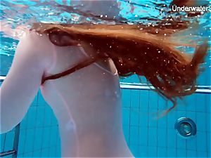 ginger-haired Simonna showing her assets underwater